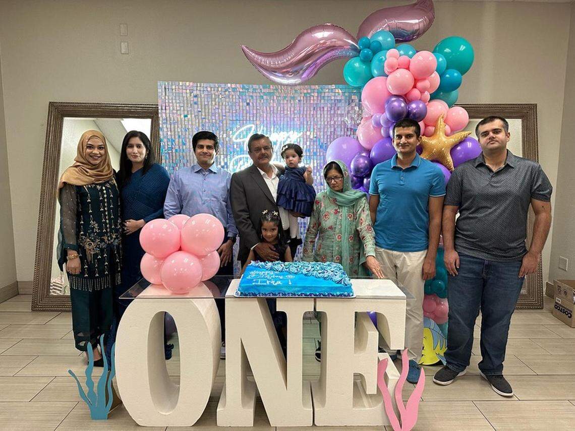 Muhammad Saddique’s family posed for a photo as they celebrated the first birthday of granddaughter Irha. From left are his daughters-in-law, Fatima Ahmad and Farwa Afzal; his son, Wasif Saddique; Muhammad Saddique holding Irha with his arm around his older granddaughter, Aaira; his wife Talat Noeen; and sons Waqas and Ammad Saddique.