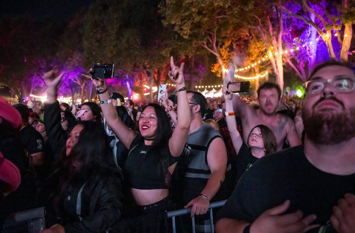 Val Miranda, center, rocks out next to her sister, Emy Miranda, both of Reno, as Avenged Sevenfold performs on the first day of Aftershock music festival in 2023 at Discovery Park in Sacramento. 
