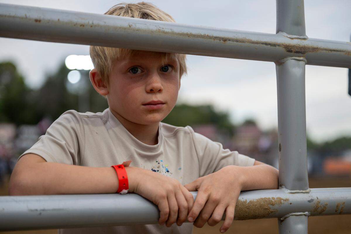 Jarret Kargl stands on the inside of the fence before a scavenger hunt for kids at the Folsom Pro Rodeo on Thursday.