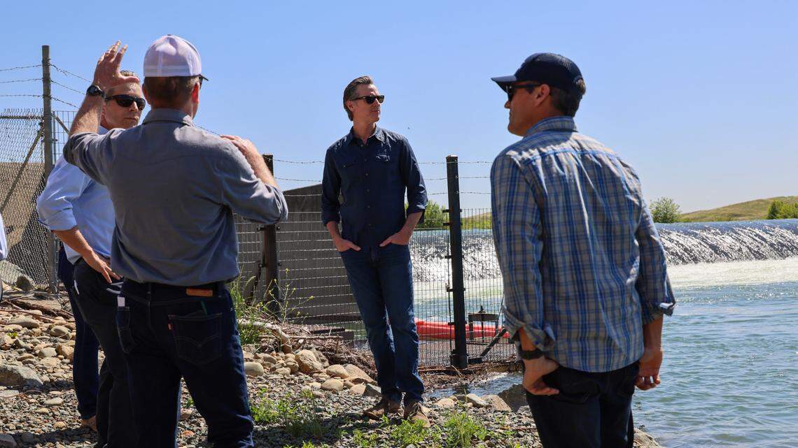 California Gov. Gavin Newsom surveys the Daguerre Point Dam on the Yuba River with state and federal officials Tuesday.