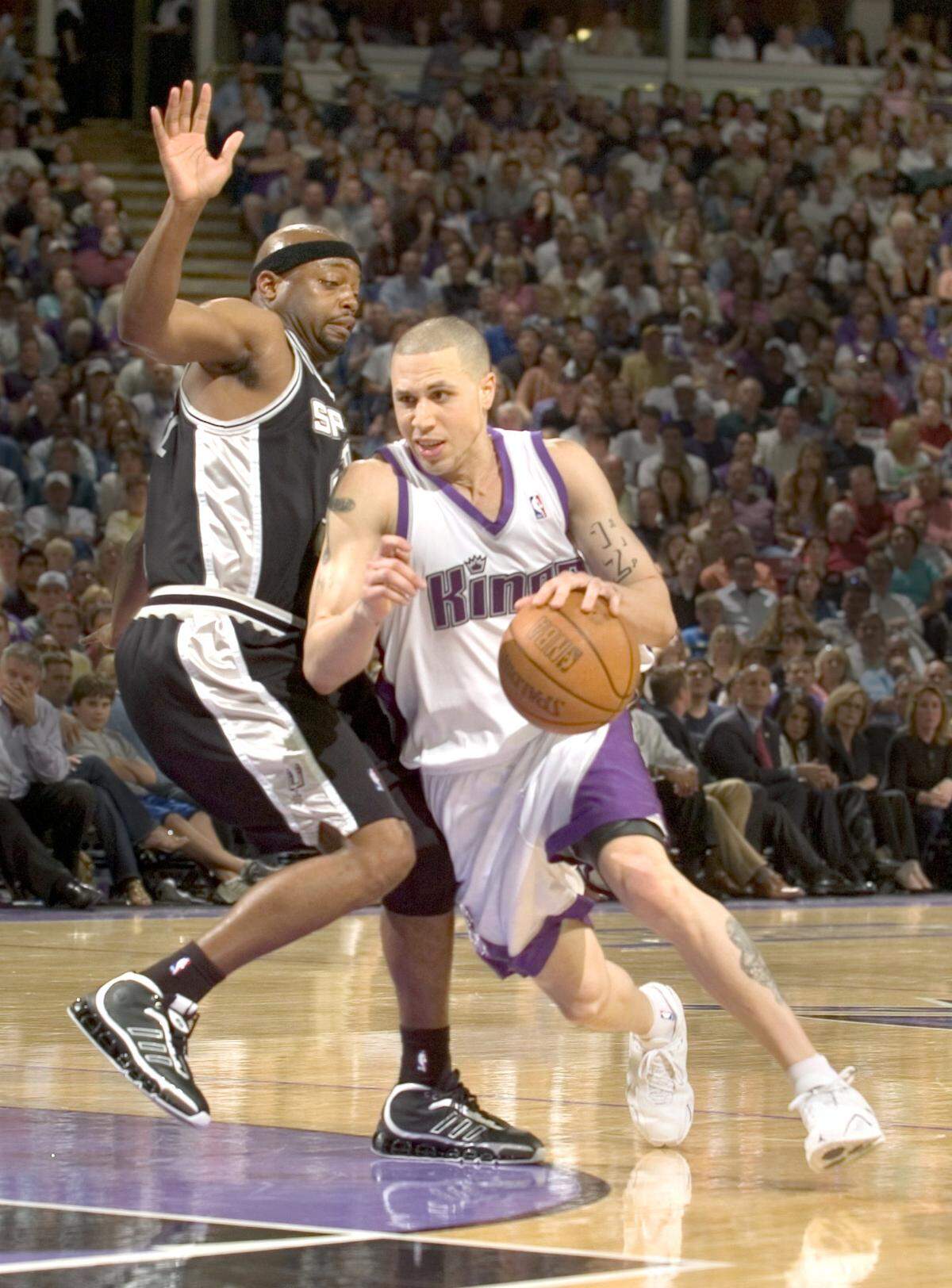 Mike Bibby dribbles around Nick Van Exel during the fourth quarter of Game 6 of the first round of Western Conference playoff series between the Sacramento Kings and San Antonio Spurs at Arco Arena on Friday, May 5, 2006. The Kings were the eighth seed.