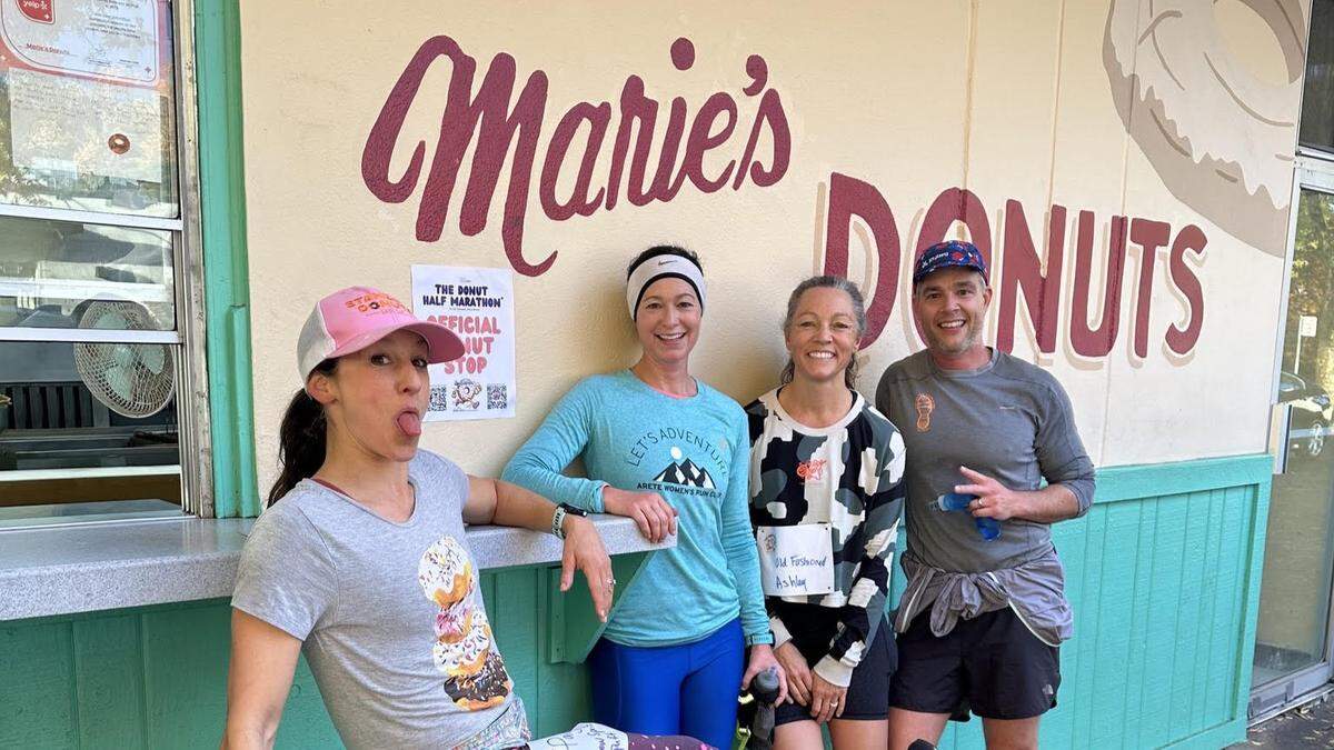 A group of Donut Half Marathon participants stop at Marie’s Donuts, 2950 Freeport Blvd., in Sacramento, during the 2024 inaugural race. Marie’s Donuts is the first stop on the 13.1-mile run that visits nine cafes and doughnut shops around town. It returns for its second year on Saturday. 