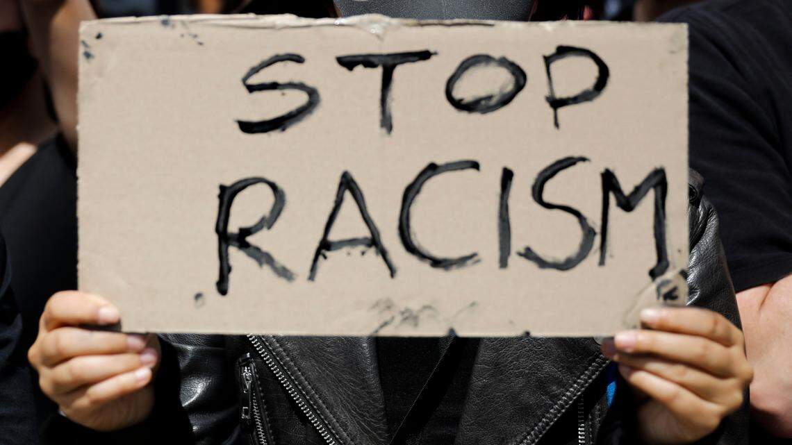 A woman holds a ‘Stop Racism’ sign as she attends a demonstration in Berlin on June 6, 2020, to protest the killing of George Floyd by police officers in Minneapolis, which led to protests in many countries and across the U.S..(AP Photo/Markus Schreiber)