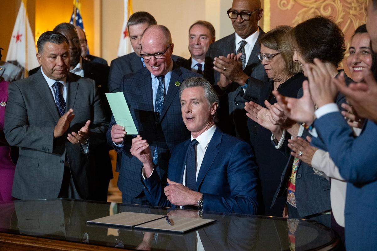 Gov. Gavin Newsom signs a bill on Monday, Oct. 14, 2024 in Sacramento.