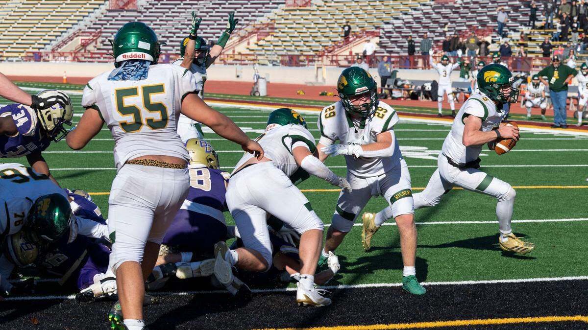 Sonora Wildcats quarterback Eli Ingalls (5) runs a keeper around the edge of the Bradshaw Christian defense to score the game-winning touchdown on a fourth and inches play in the Sac-Joaquin Section Division VI championship game at Hughes Stadium in Sacramento on Friday.