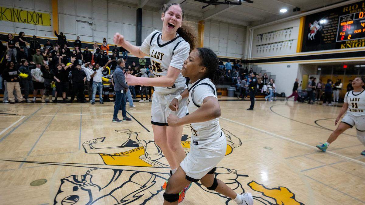 The Rio Linda Knights’ Savannah Grant (15) and LaRay Mitchell (3) celebrate following their 34-33 victory over the Marysville Indians in a CIF Northern California Division IV girls basketball quarterfinal Thursday in Rio Linda.
