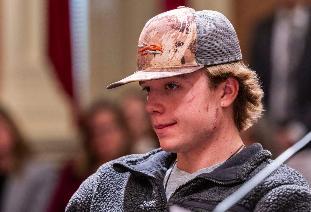 Wyatt Brooks, of El Dorado County, listens to testimony for Senate Bill 818, “Taylen and Wyatt’s Law,” on Tuesday at the state Capitol. Wyatt was injured by a mountain lion that killed his brother last year. SB 818 would allow trained dogs and their handlers to chase away mountain lions.