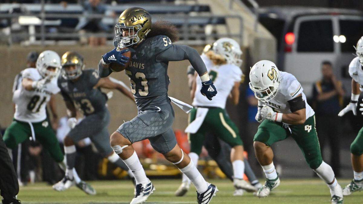 UC Davis linebacker sprints for a 78-yard touchdown after recovering a fumble during Saturday’s home win over Cal Poly.