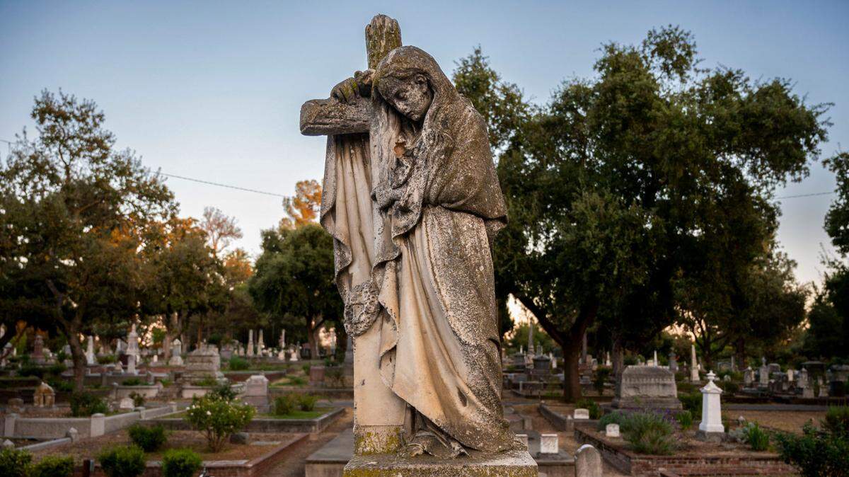 A monument depicting a person holding a cross stands among the headstones at the Old City Cemetery on Wednesday, atop the grave of Stephen A. Boutwell, who died in 1881. The cemetery, which dates to mid-19th century, has around 30,000 interments.