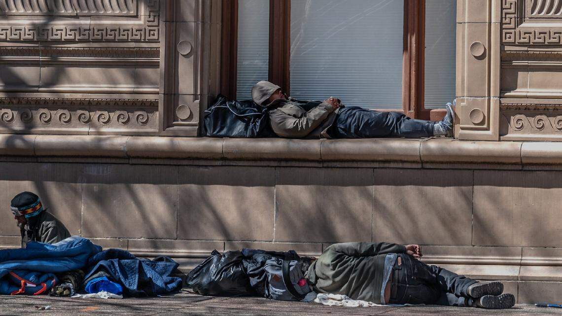 Homeless sleep in the windowsill and on the sidewalk of the Library Galleria, which opens as a warming center in the evenings, on 9th Street in downtown Sacramento on Tuesday, March 16, 2021.