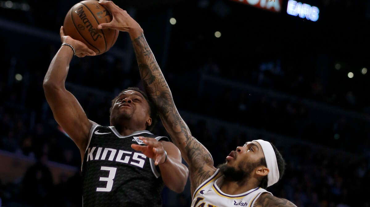 Los Angeles Lakers forward Brandon Ingram (14) blocks a shot by Sacramento Kings guard Yogi Ferrell (3) in the second half Sunday, Dec. 30, in Los Angeles. The Kings let a late lead slip away in a 121-114 loss.