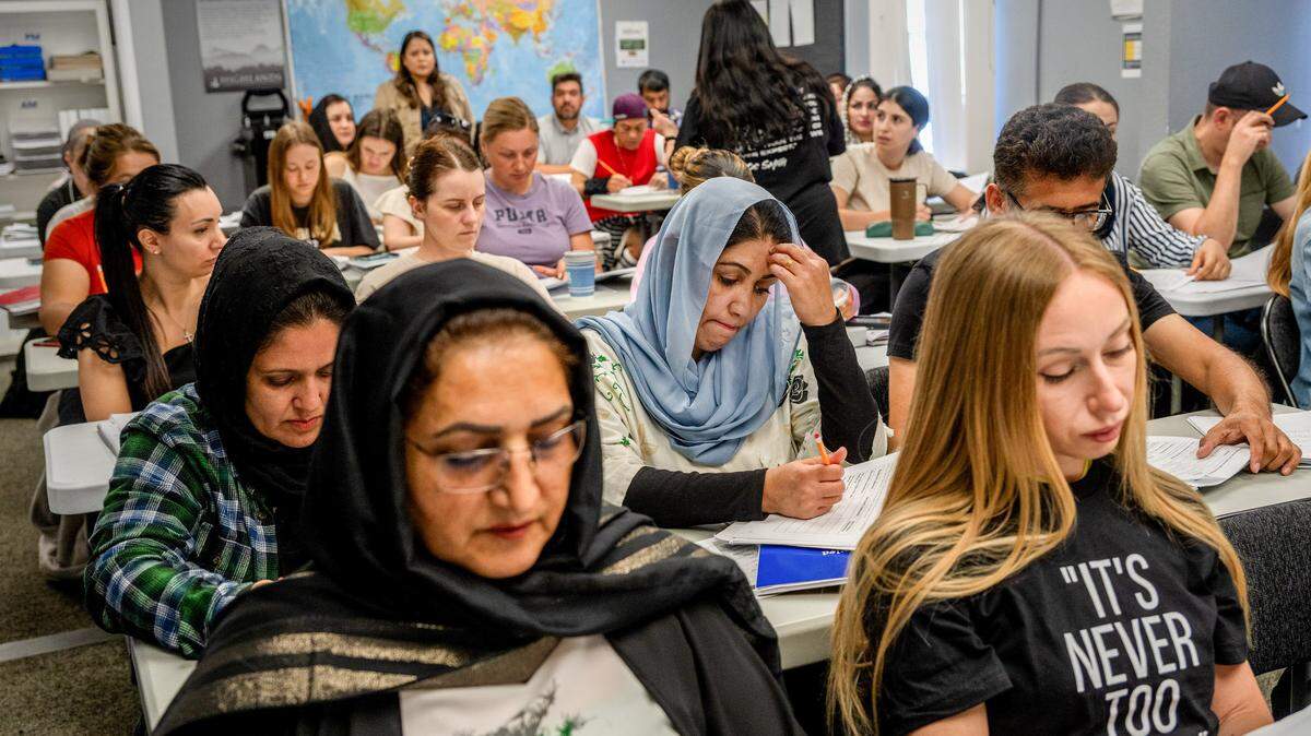 Fahima Nazari, 29, center, an Afghan refugee wearing a blue hijab, concentrates during an ESL class at Highlands Community Charter and Technical School’s Grand Avenue campus in Sacramento on May 20, 2025. If Highlands closes, thousands of Sacramento residents — mostly immigrants — will lose their lifeline to education, language and work.