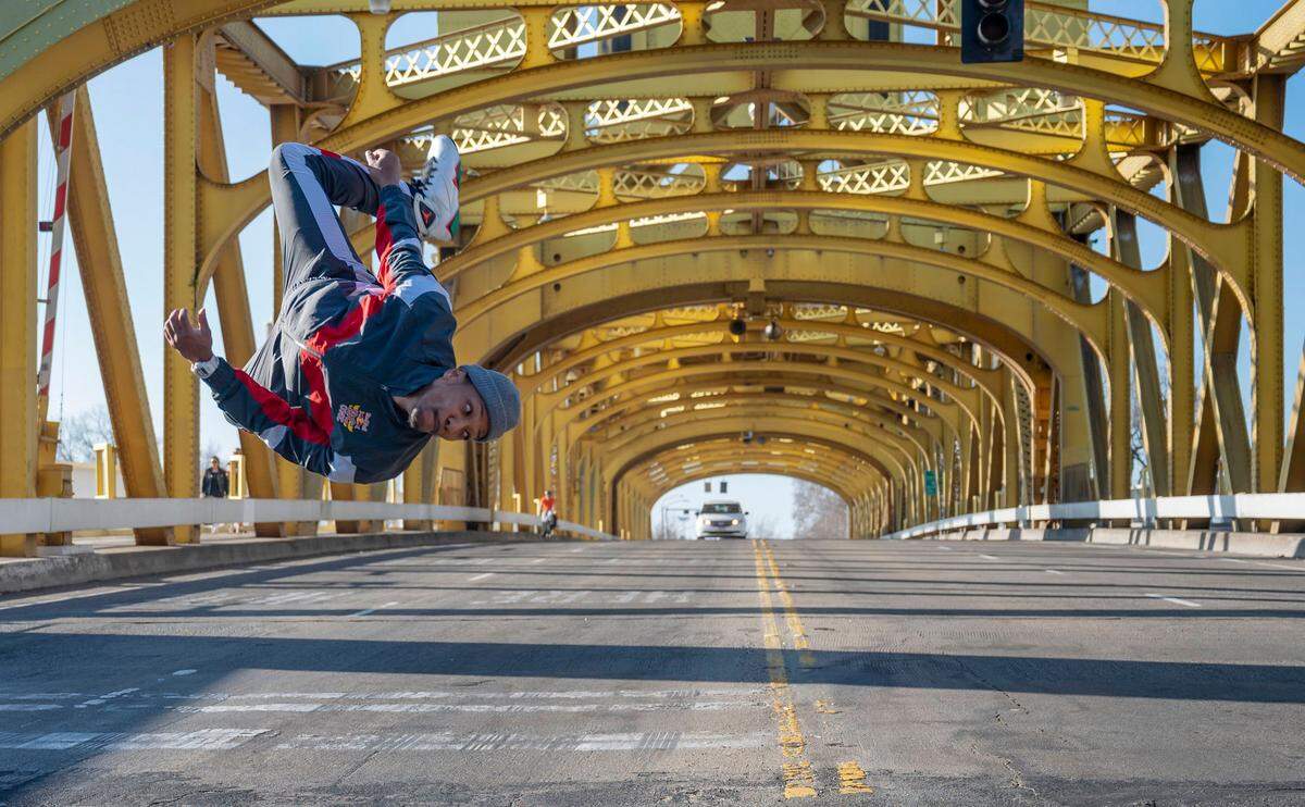 Morris Isby does a flip on Tower Bridge in January. He will be 40, nearly twice the age of some of his competitors, at the 2024 Olympics if he manages to make the first Team USA for breakdancing.
