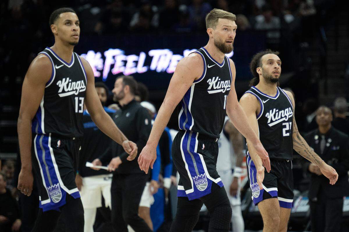 Sacramento Kings forward Keegan Murray (13) center Domantas Sabonis (11) and guard Devin Carter (22) walk to the bench during a timeout as they trail the Dallas Mavericks during an NBA play-in game at Golden 1 Center on April 16. 