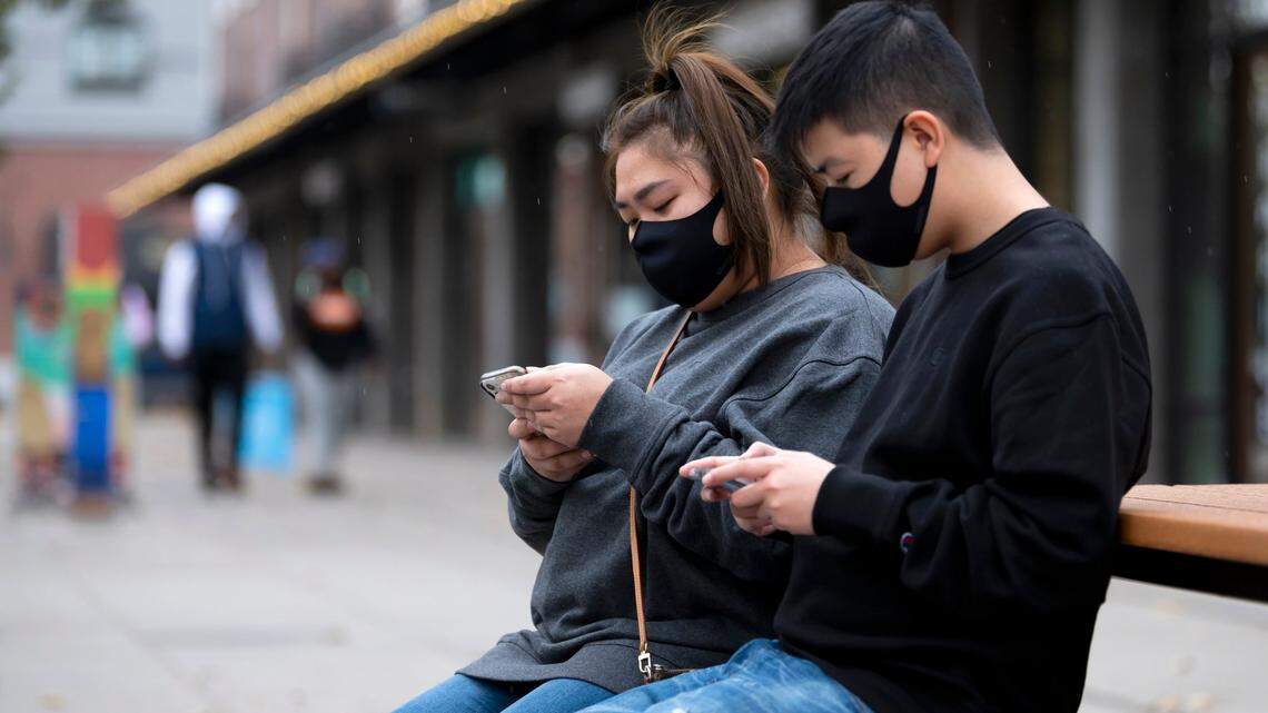 Maybeline Chong and Manny Toledo wear face comings as they wait for their takeout order from Shake Shack in the Ice Blocks on Tuesday, Nov 17, 2020 in Sacramento. Gov. Gavin Newsom issued a statewide order Monday requiring a face coverings at all times outside the home, with a few exceptions.