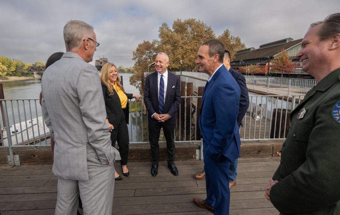 Sacramento Mayor Darrell Steinberg talks on Thursday with state Sen. Angelique Ashby and other city officials after a press conference to announce a plan to fund projects at the Old Sacramento waterfront.