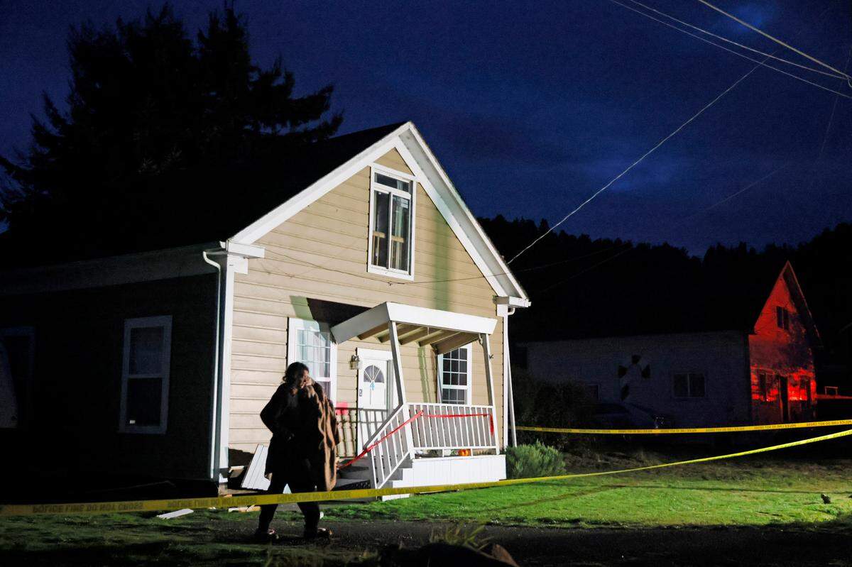 A person walks near a damaged home following an earthquake in Rio Dell, Calif., Tuesday, Dec. 20, 2022. (Santiago Mejia/San Francisco Chronicle via AP)