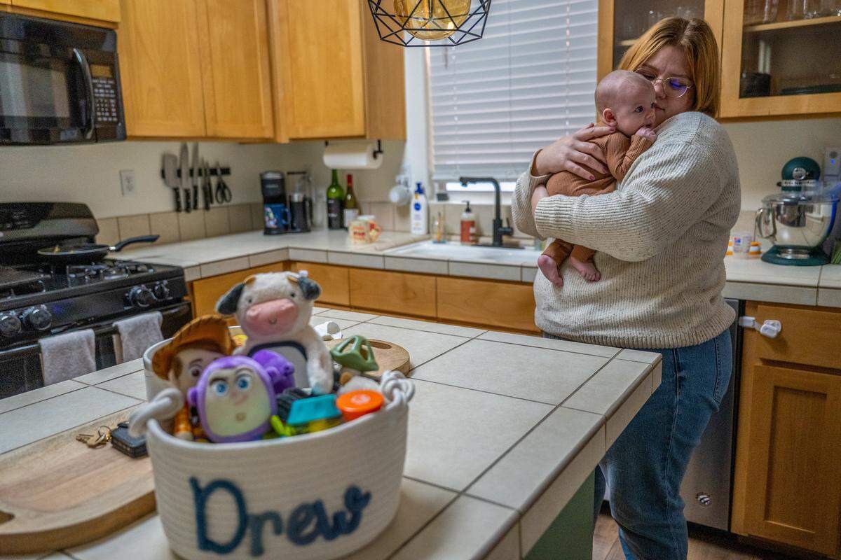 Michelle Glass holds her 2-month-old son, Andrew James Glass, near a toy basket labeled with his nickname “Drew” on Nov. 20 in Rancho Cordova. Andrew was named after his uncle, Andrew James Mathew Pringle, whose family called him “Drew Boo,” and who died in 2023 after being hit by a driver who ran a red light in Rosemont.
