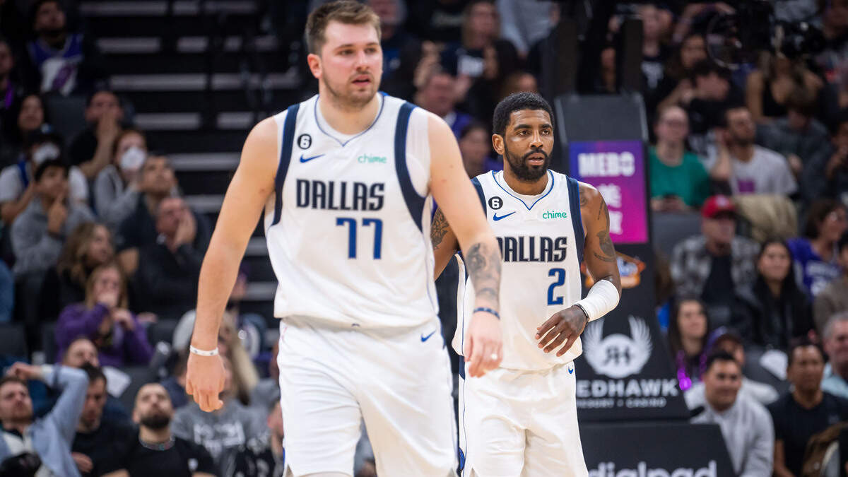 Dallas Mavericks guard Kyrie Irving (2), right, plays alongside guard Luka Doncic (77) for their first game together during the fourth quarter against the Sacramento Kings at the NBA basketball game Saturday, Feb. 11, 2023, at Golden 1 Center in Sacramento.