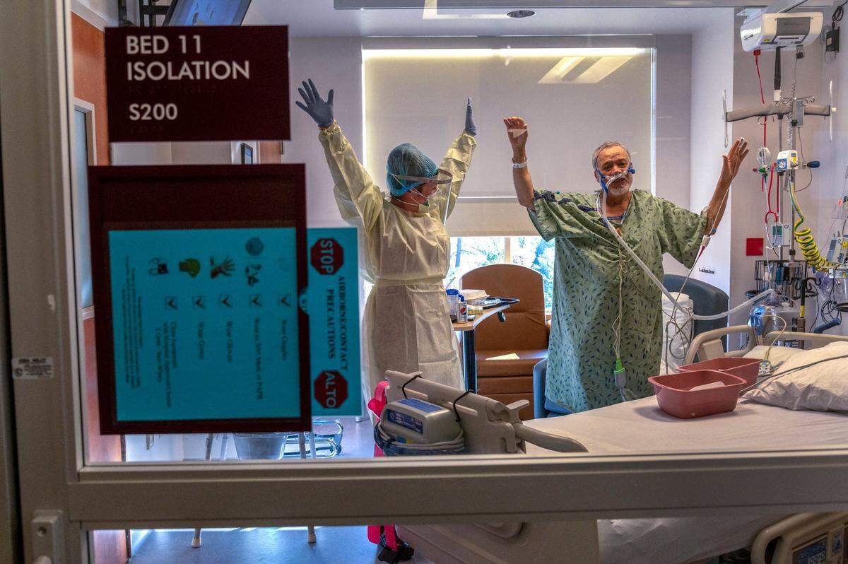 COVID patient Francisco Apolinar, right, 67, exercises with registered nurse Alina Kendler, left, inside the ICU for COVID patients at Marshall Medical Center’s hospital in Placerville on Wednesday, Dec. 2, 2020. Apolinar was a recent transfer from Tahoe Forest Hospital in Truckee. “We have been pooling our resources to work together,” said Lourdes Edralin, the hospital’s community relations director.