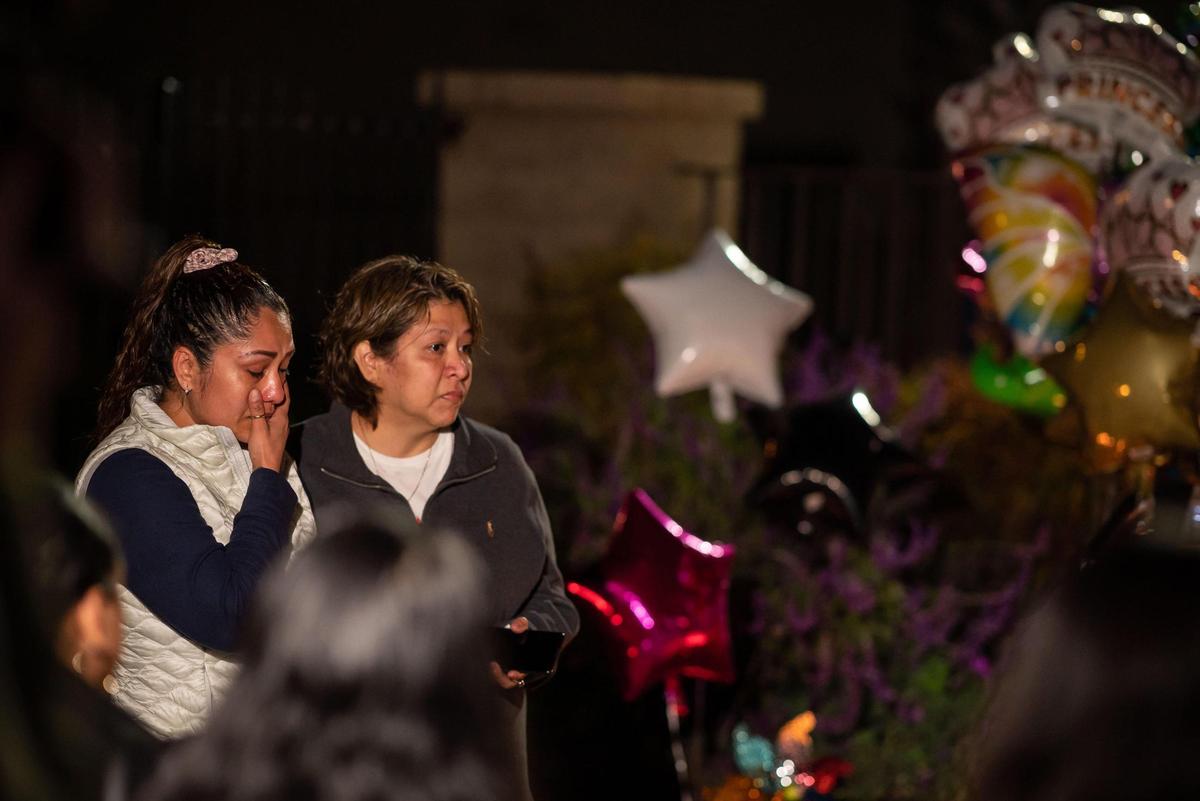 Yoana Mendoza, left, and Cecilia Lopez, who both live near Arden Arcade’s The Church in Sacramento, speak during a vigil for Samia Mora Gutierrez,13, Samantha Mora Gutierrez, 10, and Samarah Mora Gutierrez, 9, on Tuesday, March 1, 2022.
