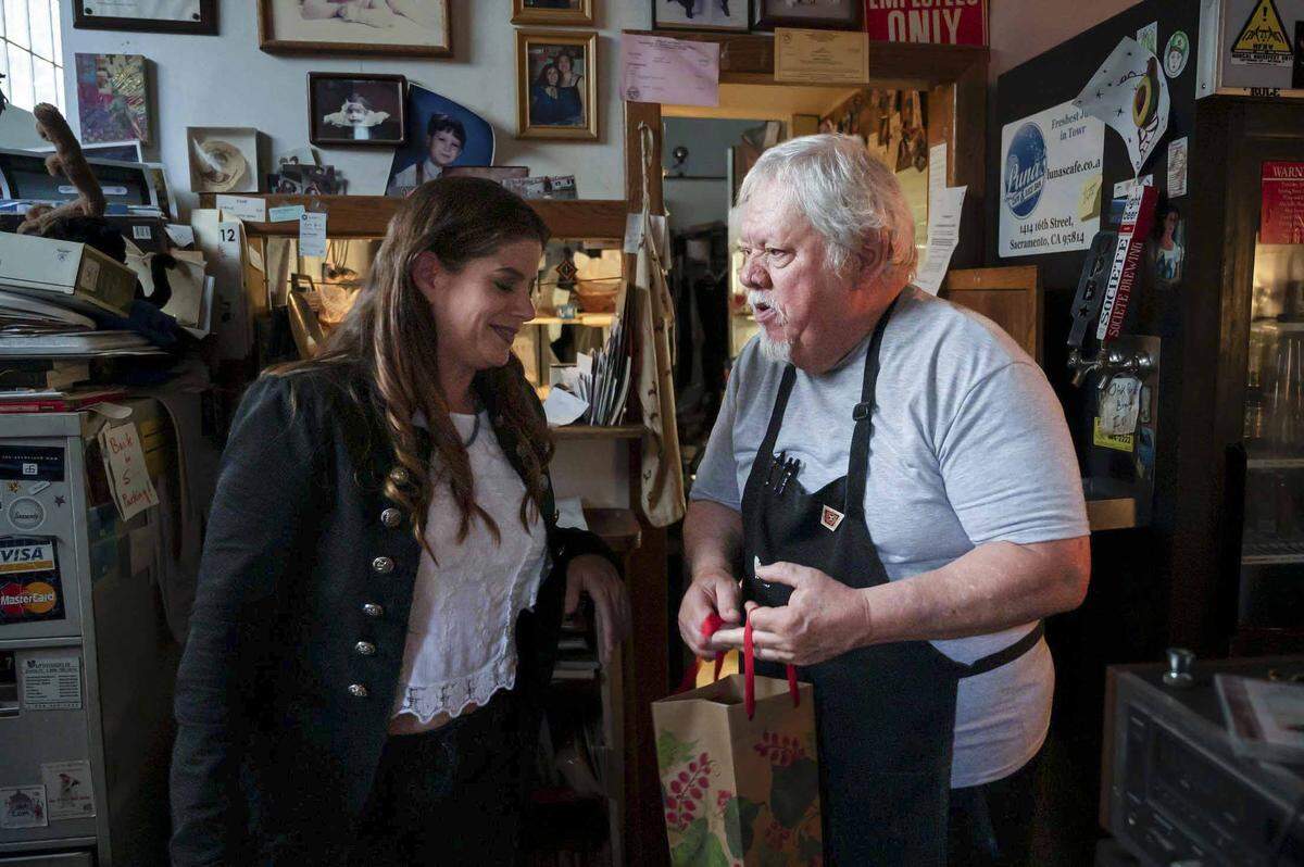 Katie Knipp of Rocklin gives Arthur “Art” Luna a “thank you” gift at Luna’s Cafe in midtown Sacramento. Luna’s Cafe will close at the beginning of August after 40 years of business.