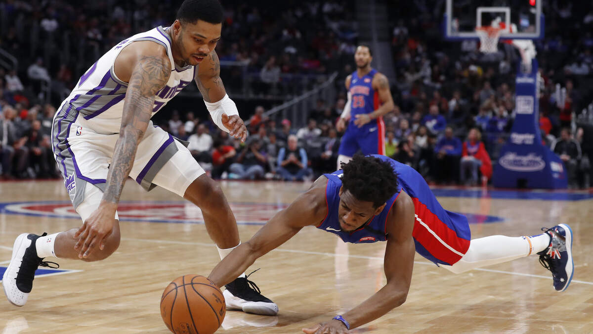 Detroit Pistons guard Langston Galloway, right, and guard Kent Bazemore chase the loose ball during the first half of an NBA basketball game, Wednesday, Jan. 22, 2020, in Detroit. (AP Photo/Carlos Osorio)