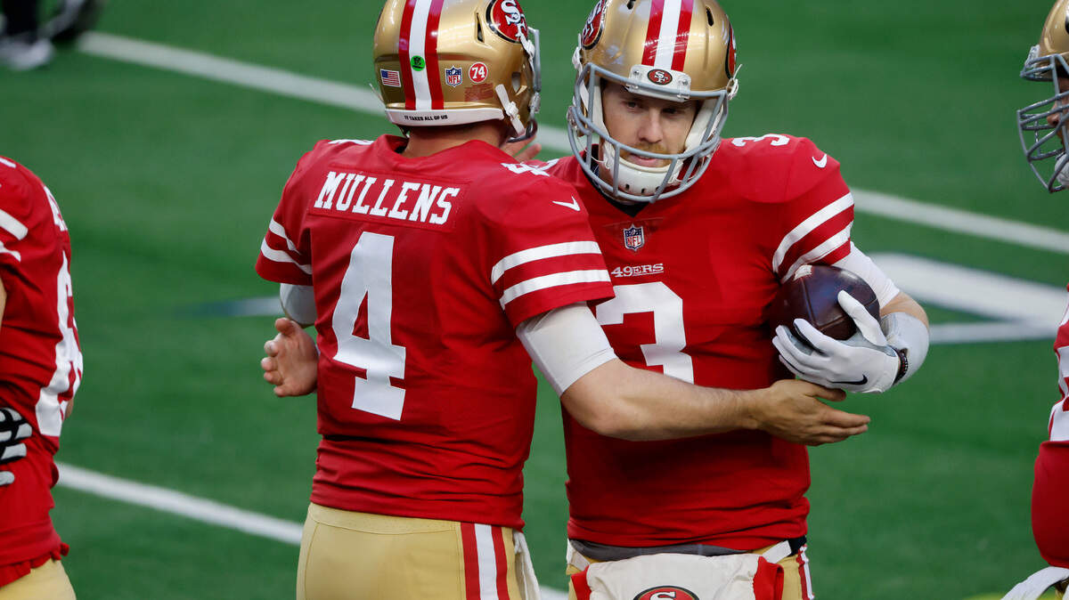 San Francisco quarterbacks Nick Mullens (4) and C.J. Beathard (3) greet each other before last week’s game with the Dallas Cowboys.