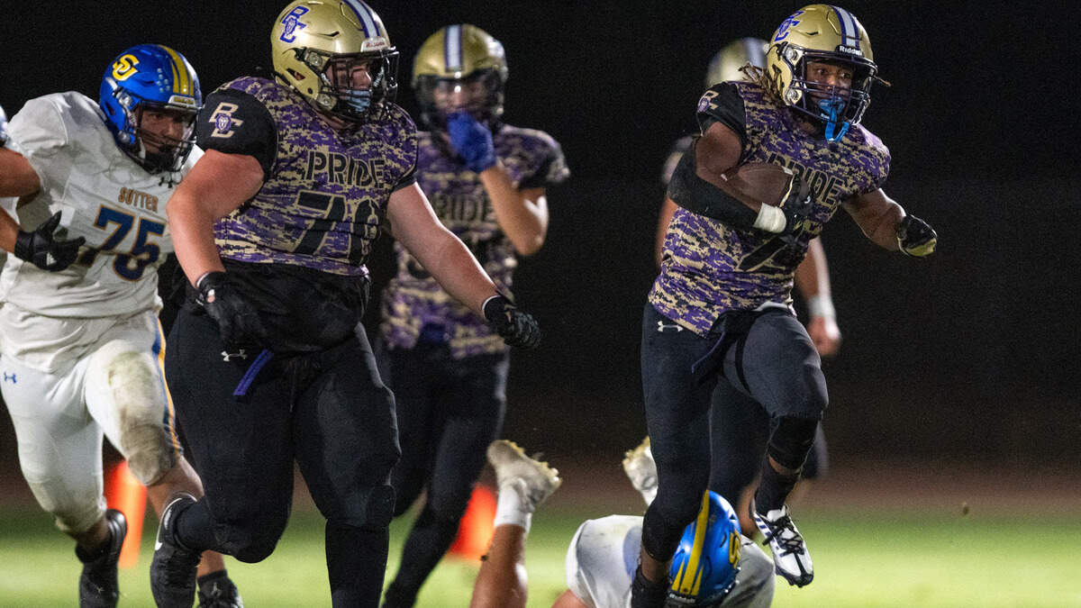 The Bradshaw Christian Pride's Devin Hatcher (2) picks up a big gain on a draw play in the fourth quarter against the Sutter Huskies in Vineyard on Friday.