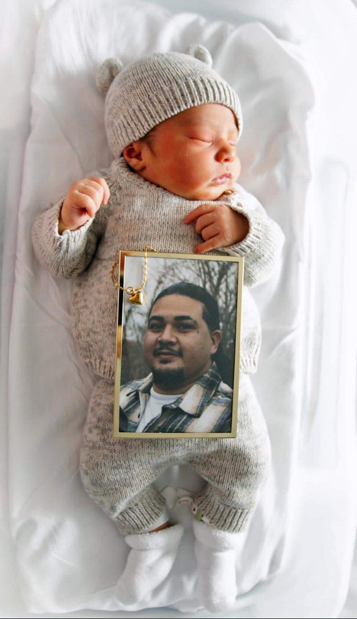 A framed photograph of Joel Melendez Jr. rests on his son Jeremiah Melendez, who was born in November 2025. Joel was killed on July 1, 2025 in a fireworks explosion in Esparto.