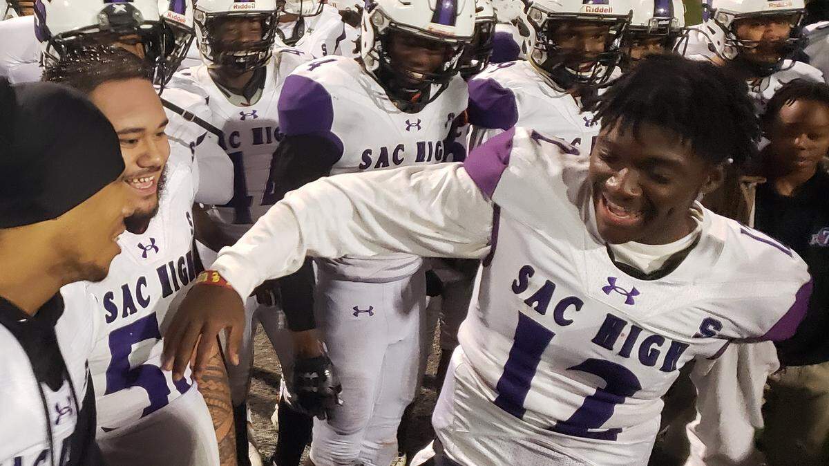 Sacramento Dragons quarterback Le’Ron James-Radcliffe (12) celebrates with his teammates after a 45-38 win over the Roseville Tigers in a Sac-Joaquin Section Division IV quarterfinal on Friday.
