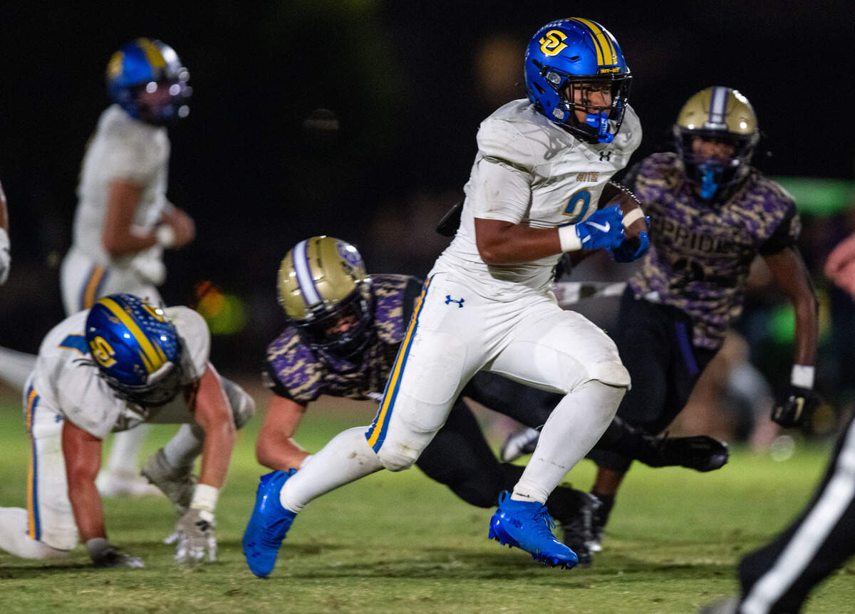The Sutter Huskies' Losi Asiata (2) rushes for a first down in the third quarter against the Bradshaw Christian Pride in Vineyard on Friday.
