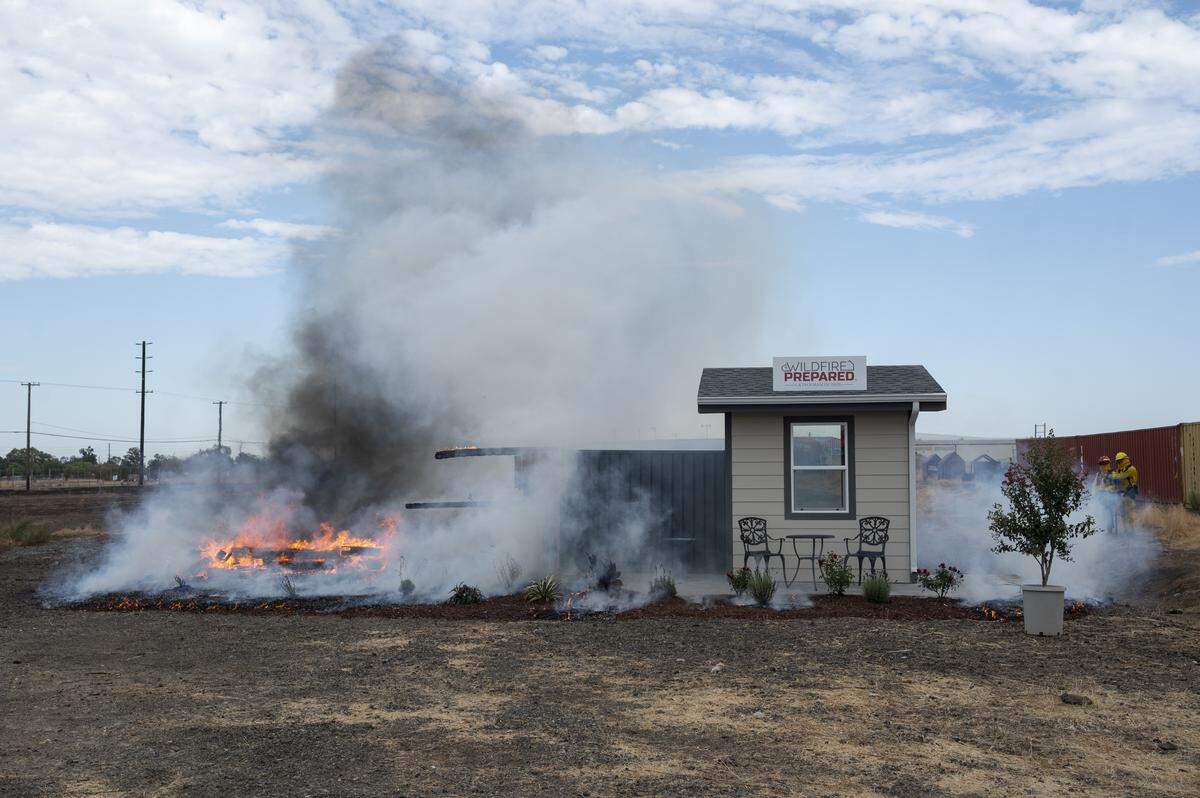 A temporary structure that lacked “zone zero” preparations is reduced to ash during a burn demonstration at the Sacramento City Fire Training Facility at McClellan Airfield on Wednesday, Sept. 24, 2025. Cal Fire and IBHS hosted the burn to demonstrate the impact of proposed “zone zero” regulations in a wild fire scenario.