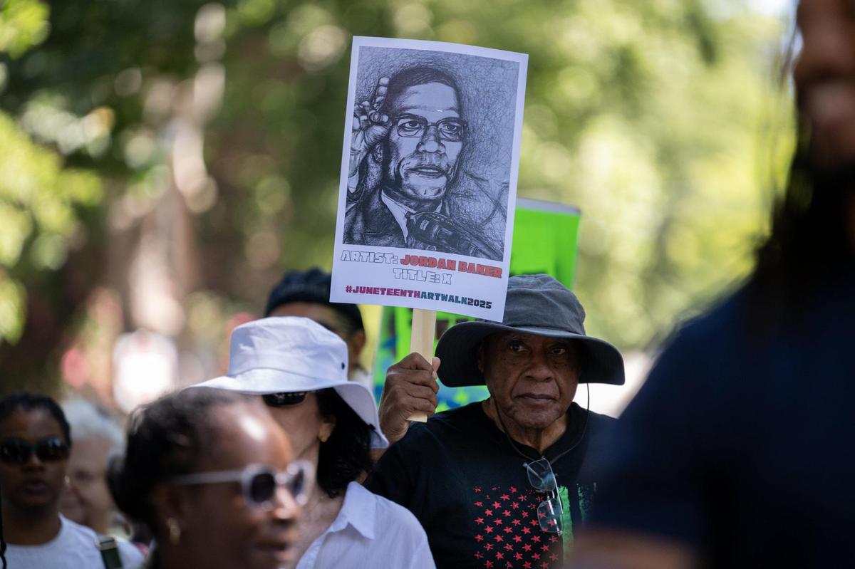 Participate walk to music of the New Orleans-style Element Brass Band towards the Capital Stage of the during the second annual Juneteenth Art Walk on Thursday in Sacramento.