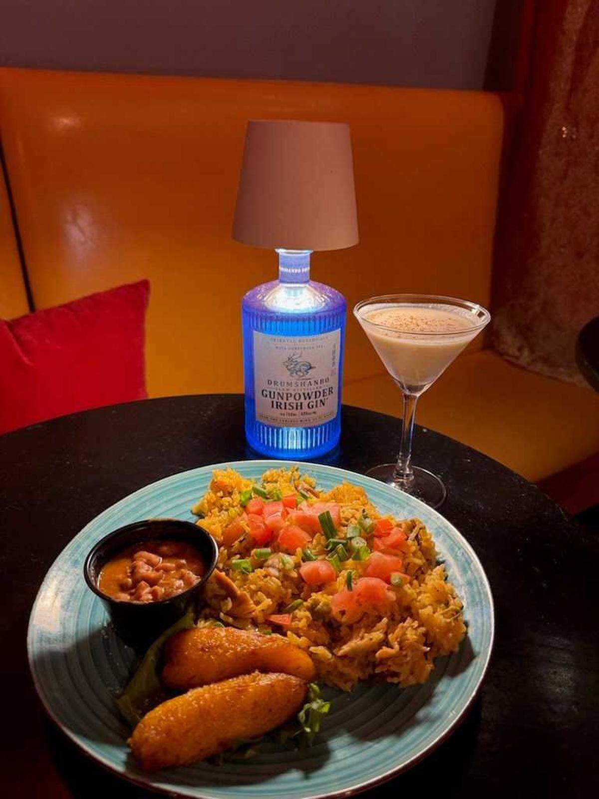 Arroz con pollo, sautéed chicken and rice served with beans and maduritos (sweet plantains) at Lola's Lounge in Land Park.
