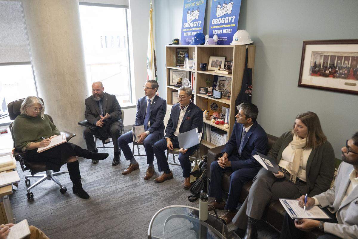 Members of the Professional Engineers in California Government labor union speak about a telework bill with Julie Sauls, chief of staff for state Sen. Roger Niello, at the Capitol Swing Space in Sacramento on Wednesday.