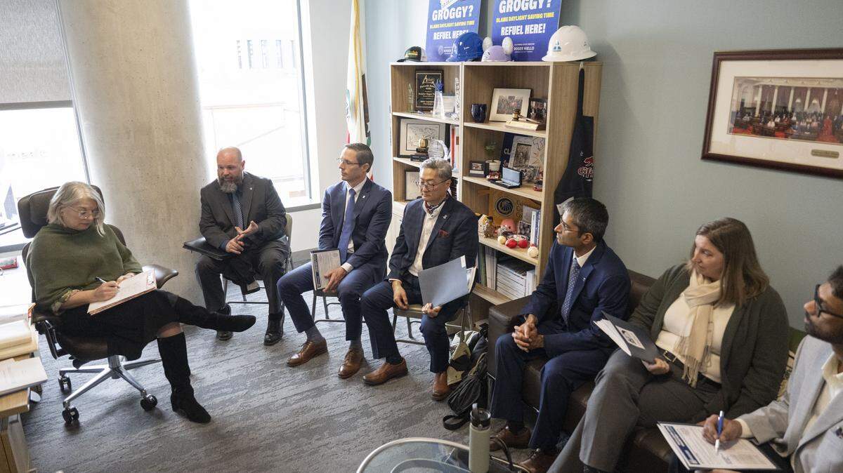 Members of the Professional Engineers in California Government labor union speak about a telework bill with Julie Sauls, chief of staff for California Sen. Roger Niello, at the Capitol Swing Space in Sacramento. Return-to-office policy risks savings and recruitment in California.