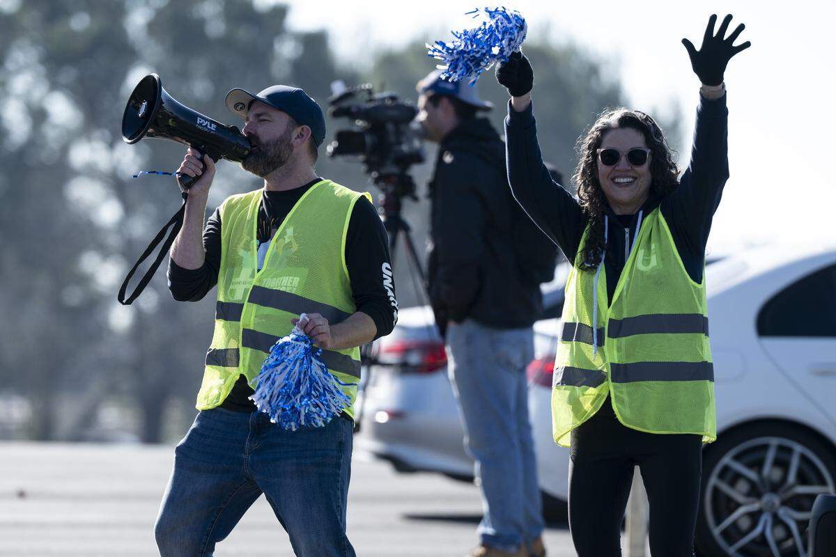Gina Yarbrough, a physical therapist and UNAC/UHCP representative, right, and Kurt Hankins, an ANTC affiliate officer, hype up the crowd during a strike outside Kaiser Permanente’s Roseville Medical Center in Roseville on Monday, Jan. 26, 2026.