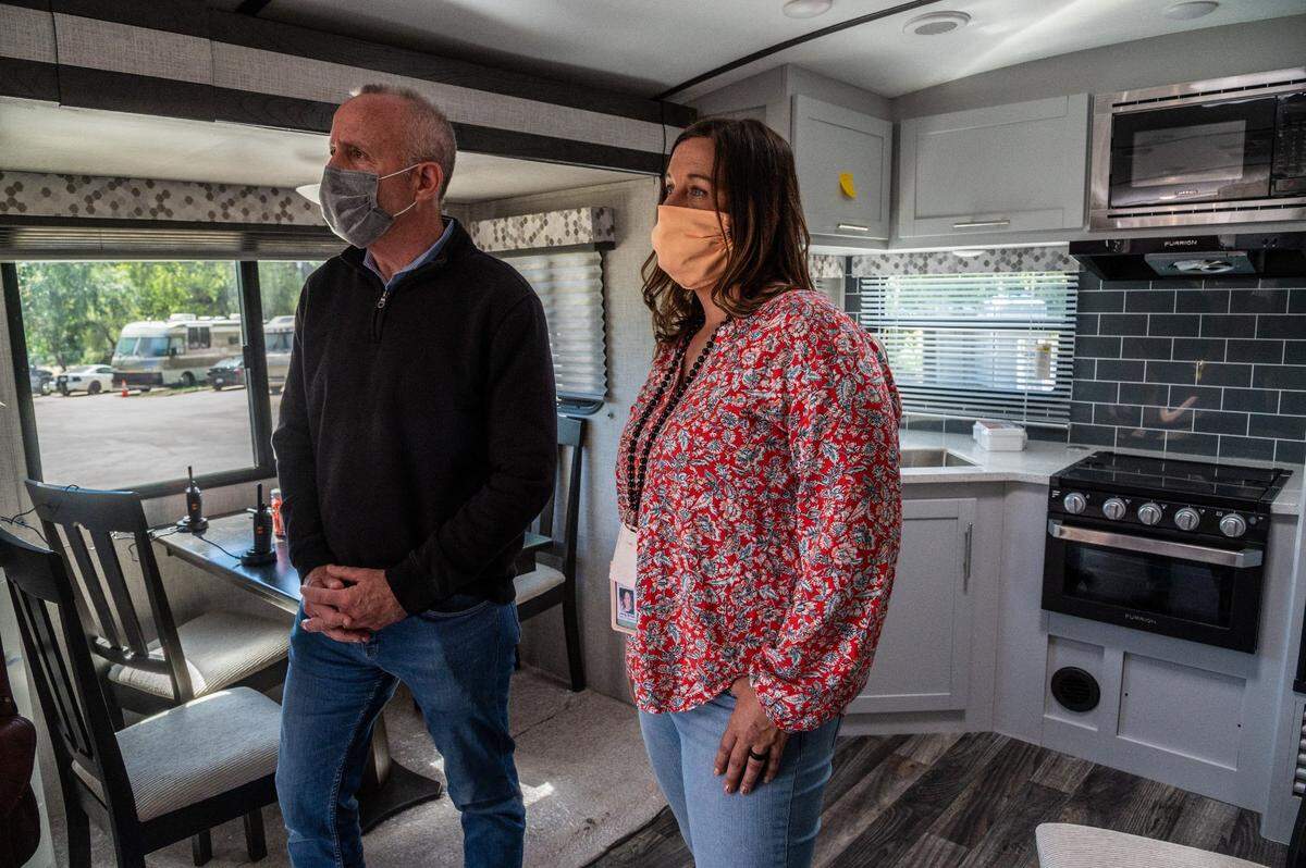 Sacramento Mayor Darrell Steinberg and Jenny Jordan, program supervisor for First Step Communities on contract with the city, tour a service trailer on Wednesday, April 7, 2021 at the “Safe Ground” site at Miller Park where homeless residents utilizing the site will be entered into the Homeless Management Information System, connecting them with additional service providers in the area.