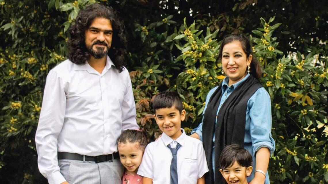 Mujeebullah Amiree, left, poses for a family photo with his wife Khadeja in Sacramento. The family moved to California in 2017.