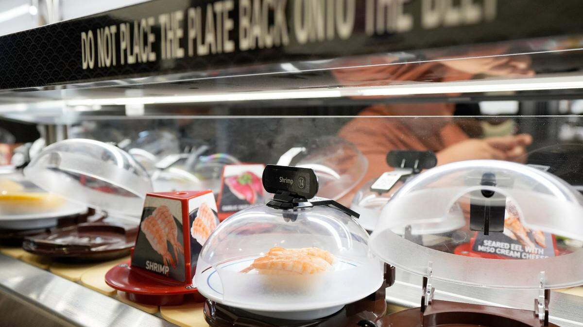 A conveyor belt rotates plates at Kura Revolving Sushi Bar in Columbus, Ohio, on Jan. 18, 2024. The chain will open in Roseville, California, on Friday, May 10.