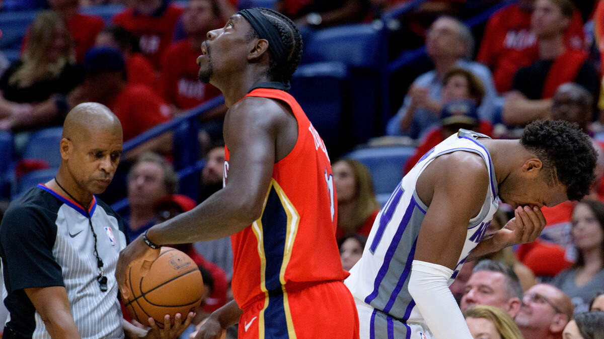 New Orleans Pelicans guard Jrue Holiday (11) looks up as he is called for a foul against Sacramento Kings guard Buddy Hield (24) in the first half of an NBA basketball game in New Orleans, Friday, Oct. 19, 2018. (AP Photo/Matthew Hinton)