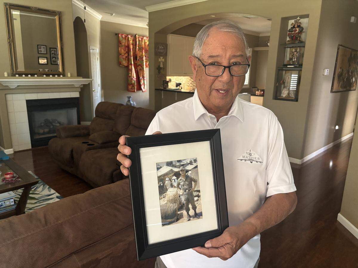 Jim Gines, 83, who lives in unincorporated Sacramento County, holds a framed photo of Manuel Gines, his late brother. Manuel Gines died in 1968, during his second tour of duty in the Vietnam War.