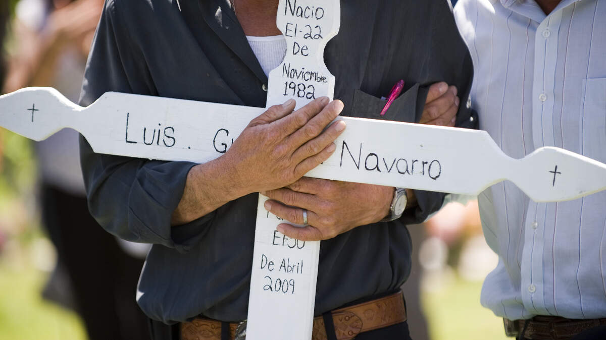 WOODLAND, CA. MAY 7:
Santos Gutierrez embraces the cross bearing his son’s name, Luis Gutierrez Navarro, at his gravesite on Thursday, May 7. He was was shot by Yolo County Sheriff’s deputies on April 30. 
Woodland, California May 7, 2009.
Showcase 2009