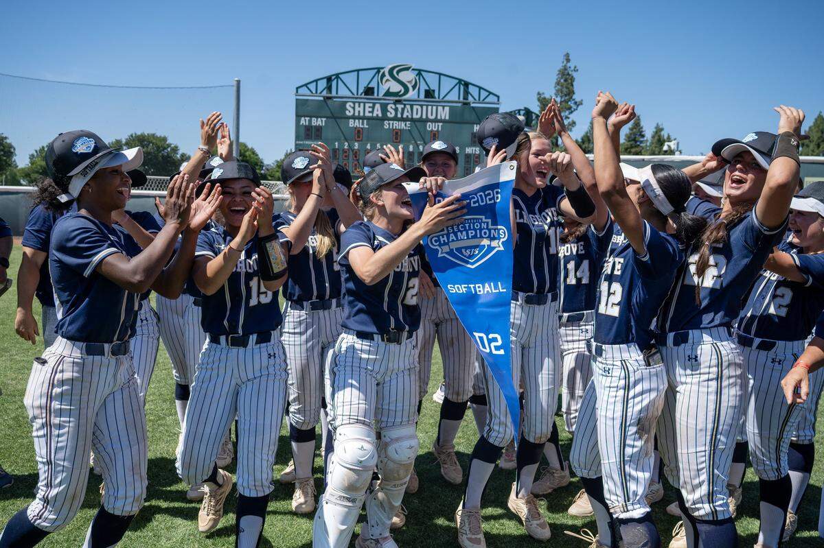 The Elk Grove Thundering Herd softball team celebrates following their 3-2 victory over the Del Oro Golden Eagles on Saturday in the CIF Sac-Joaquin Section Division II softball championship at Sacramento State.
