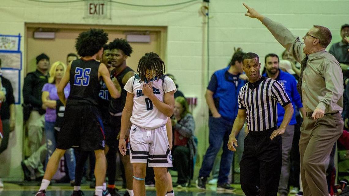 Folsom's Martis Johnson (13) is bumped by teammate Mason Forbes (25) after making a 3-pointer as he was fouled by Sheldon's Dale Currie (0) to tie the score late in the fourth quarter. Folsom coach Mike Wall, right, reacts to the play.
