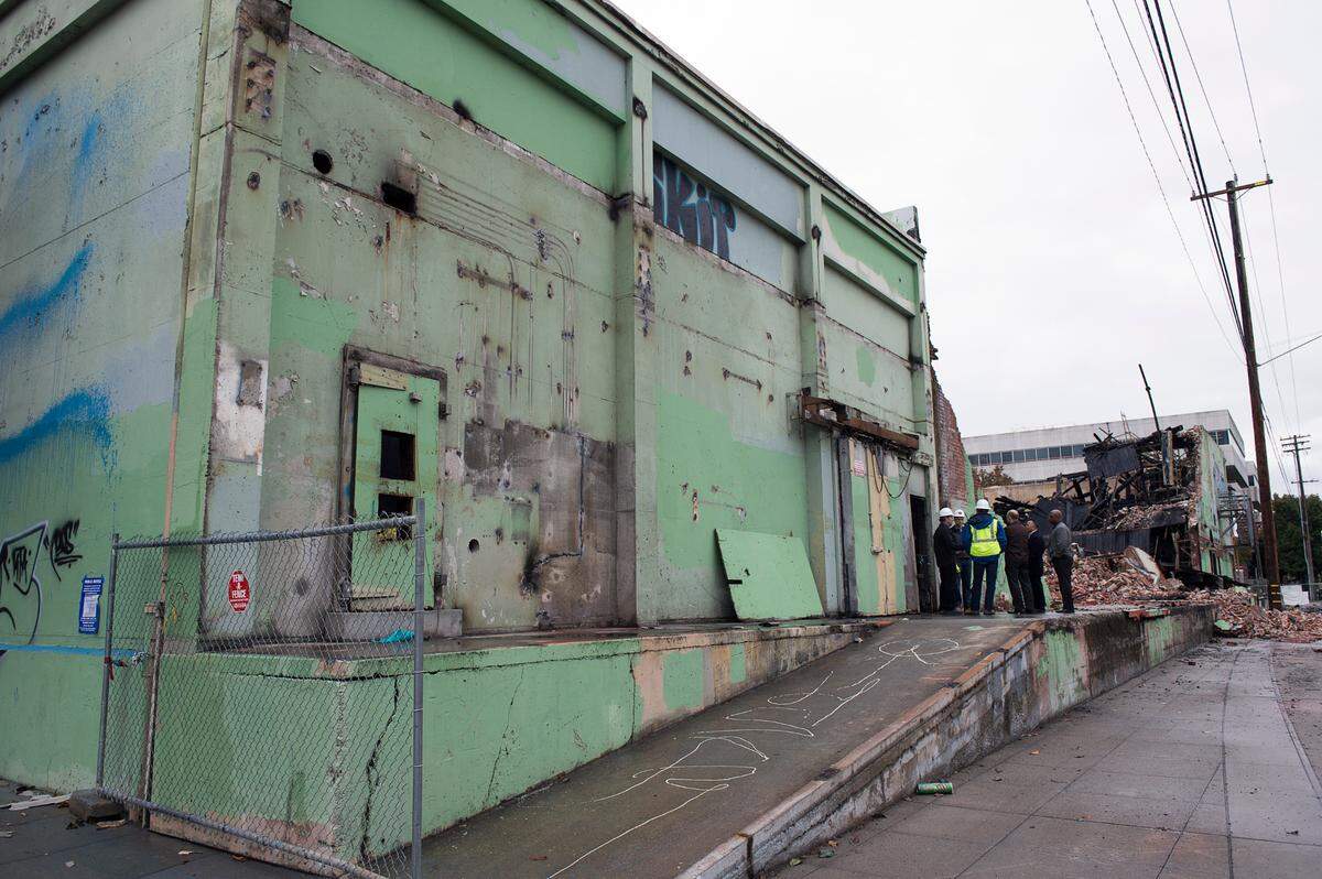 Contractors inspects fire damage to a vacant warehouse along the R Street corridor in 2015.