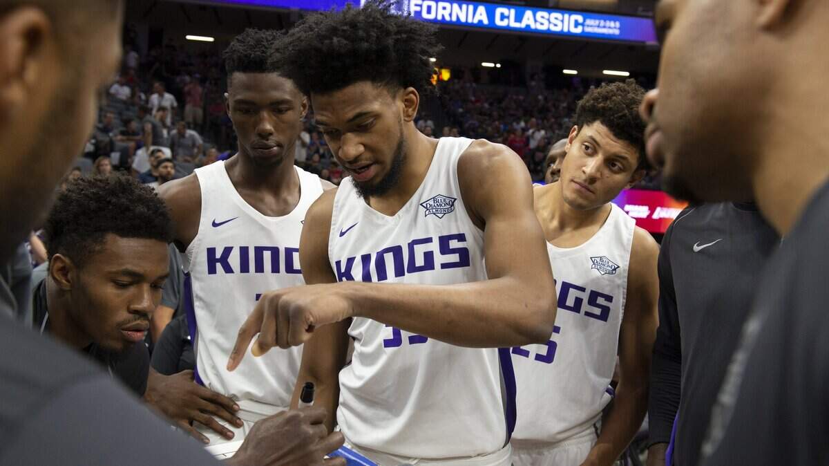 Marvin Bagley III, center, is flanked by Harry Giles III and Justin Jackson before tip-off against the Golden State Warriors in the California Classic on July 3 in Sacramento. The team’s Media Day is Monday and training camp begins Tuesday.
