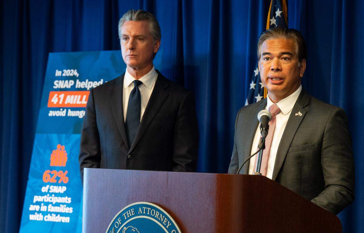 El fiscal general de California Rob Bonta, acompañado por el gobernador Gavin Newsom, habla el martes en una conferencia de prensa en Sacramento sobre una demanda presentada por California y otros estados en un tribunal federal para restablecer la financiación del Supplemental Nutrition Assistance Program. Los beneficios de SNAP, que proporcionan alimentos a unos 5,5 millones de residentes del estado en California como CalFresh, podrían detenerse en días en medio del cierre del gobierno federal.