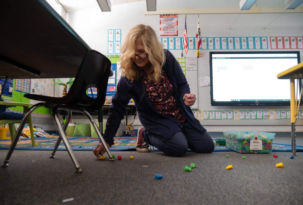 Kindergarten teacher Kirstin Harding picks up learning toys after the end of the morning session of class at Peter J. Shields Elementary School in Rancho Cordova on Monday. The school will switch to full-day kindergarten next year.
